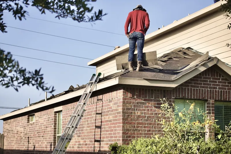Professional roofer working on a residential roof in Bishops